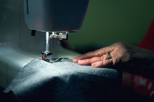 person stitching a suit